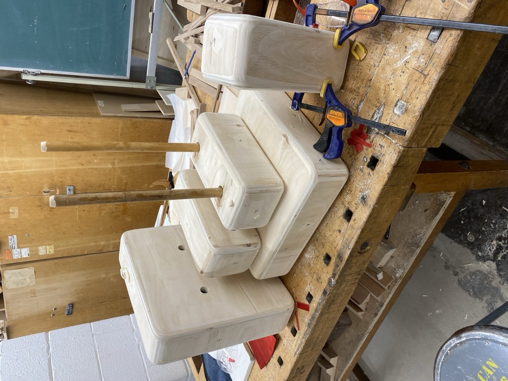 The five blocks, base and dowels laid out on a workbench
