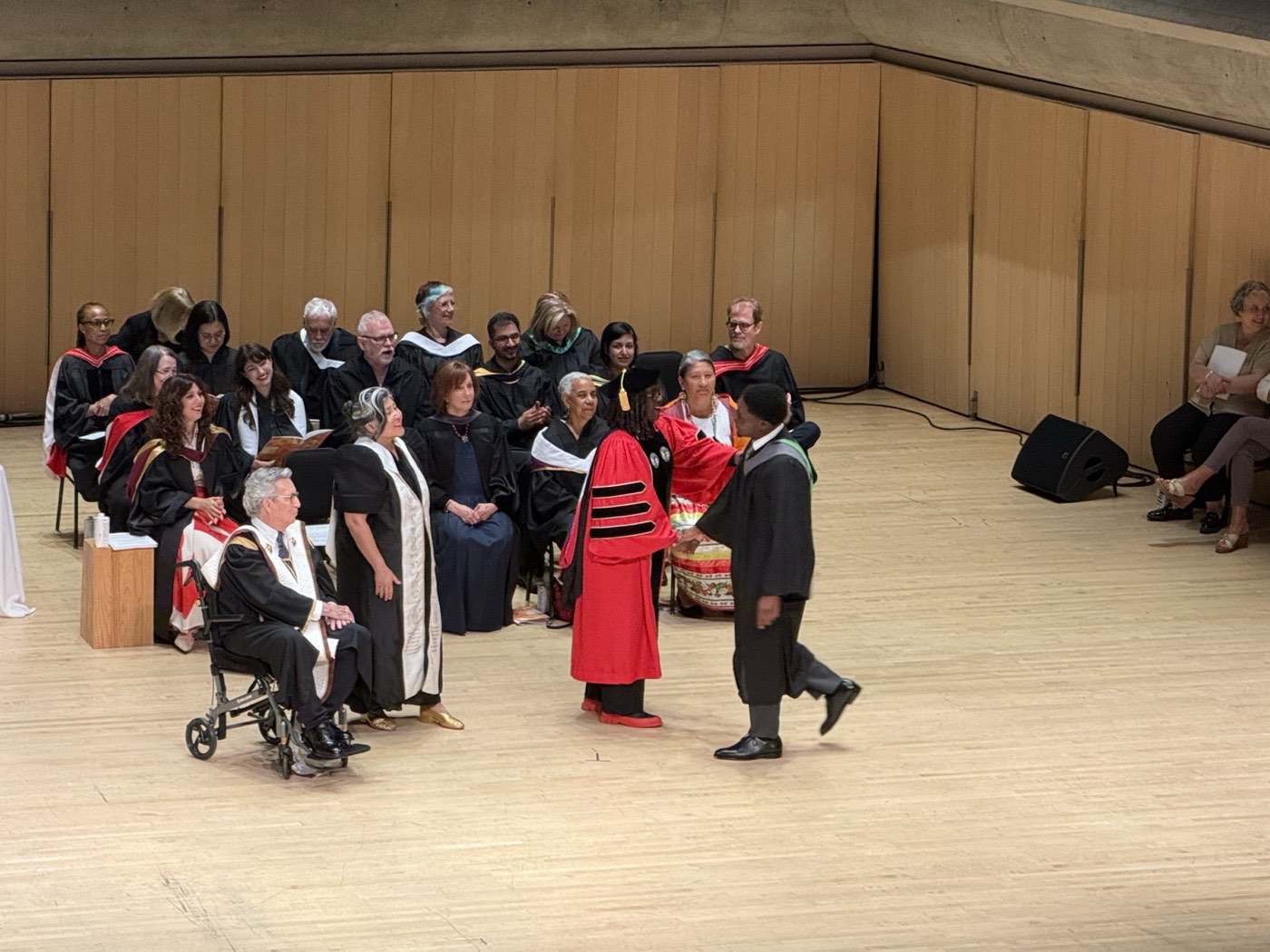 David crossing the stage at his graduation in Roy Thomson Hall
