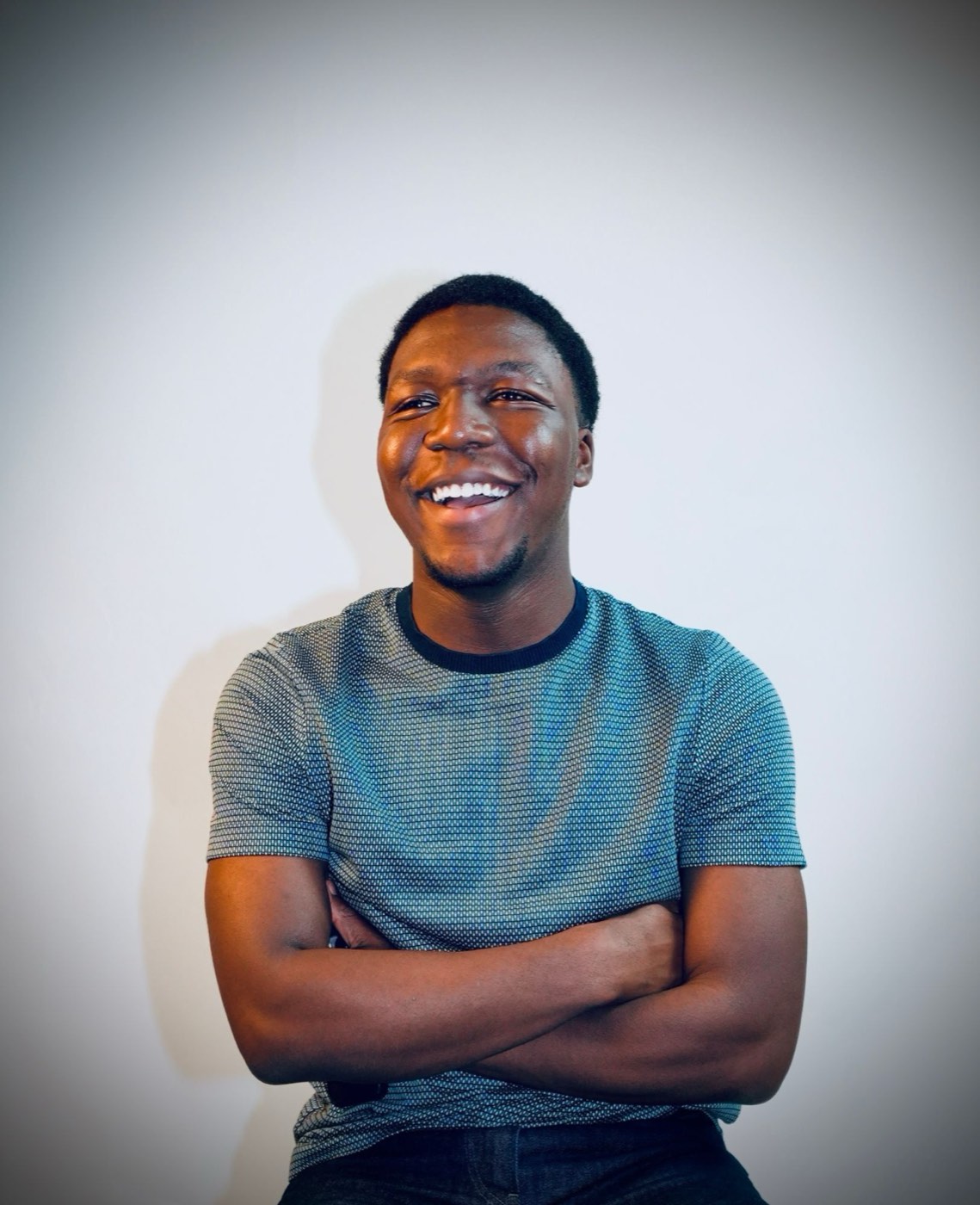 David Chidi Emmanuel laughing, arms crossed